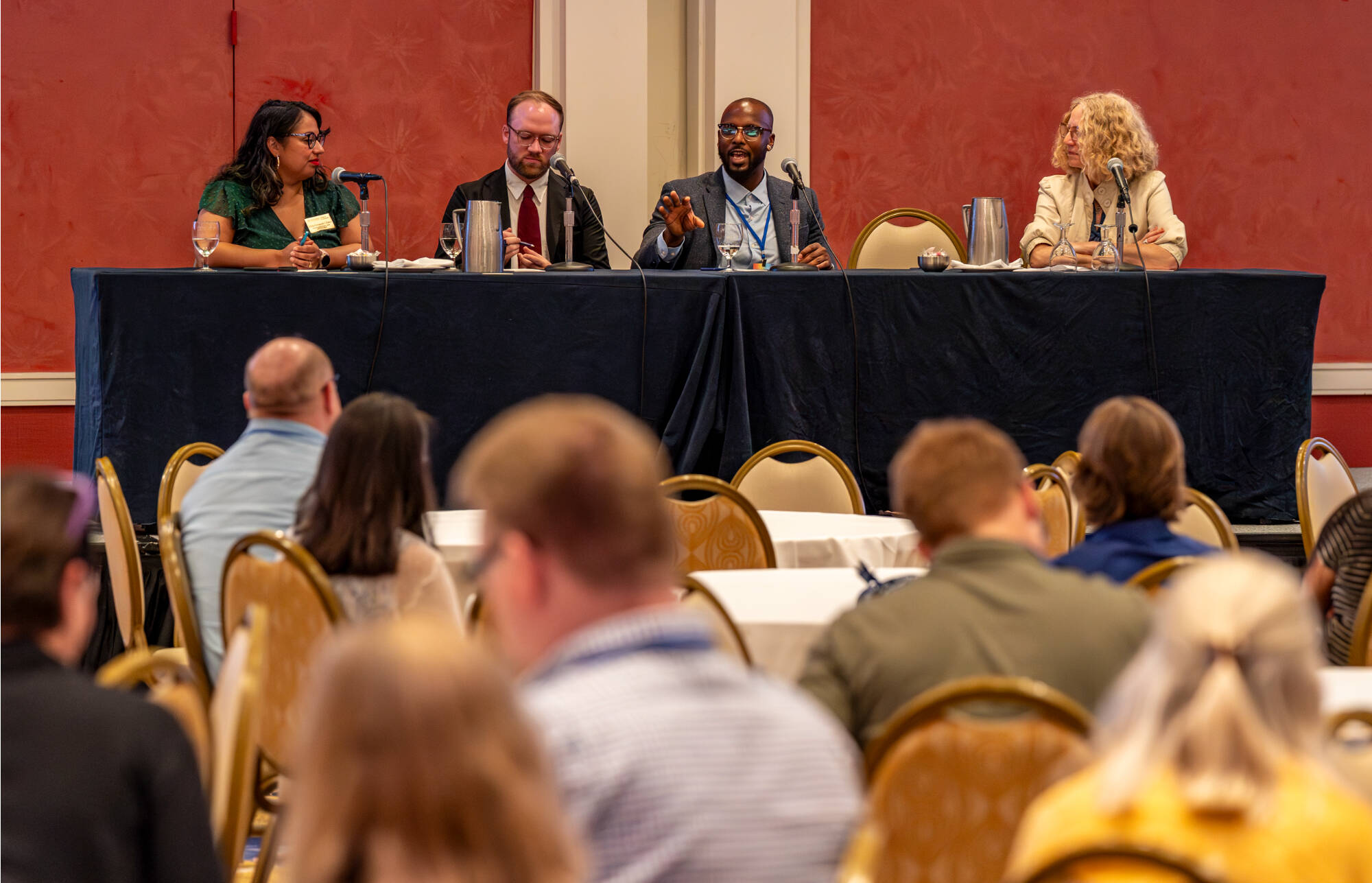 (From left) Delia Fernández-Jones '10, Landon Hughes '14, Nkrumah Grant '14 and Jennifer Drake, provost and executive vice president for Academic Affairs, take part in a panel during the ConnectUR conference at the Amway Grand Plaza Hotel in Grand Rap...